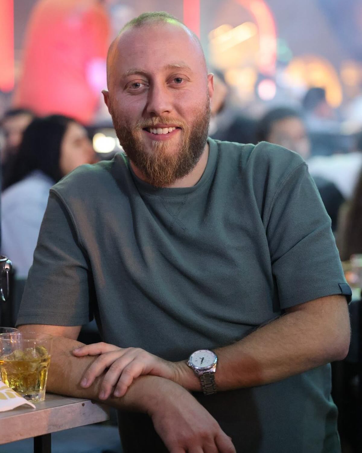 Charbel, director of Catchers, at a table smiling at the camera